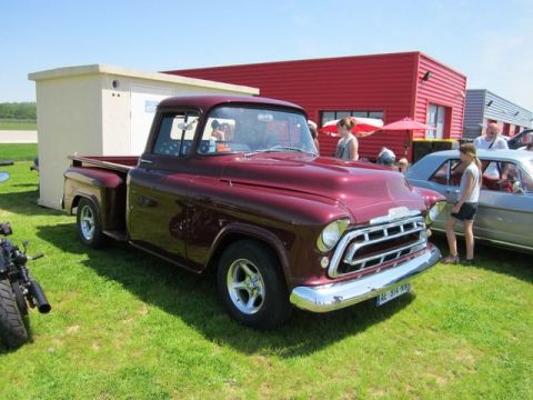 1991 Ford LTD Crown Victoria - Maroon 1955 Chevrolet pickup truck at an outdoor car show.