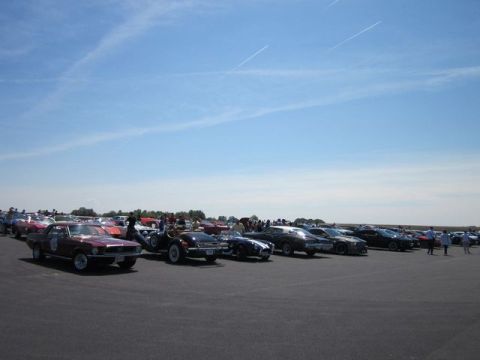 1991 Ford LTD Crown Victoria - A variety of vehicles are gathered outdoors on a sunny day.