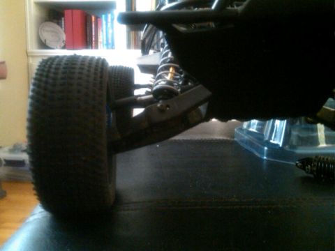 1986 Ford Bronco - The suspension and knobby tire of a remote control car are visible in this close-up shot.