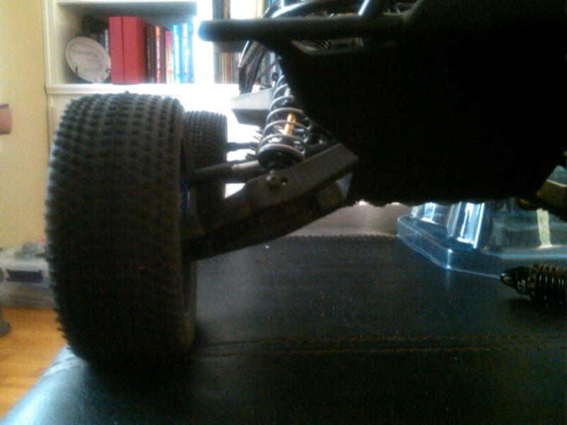 close-up of a remote control car's front wheel and suspension system