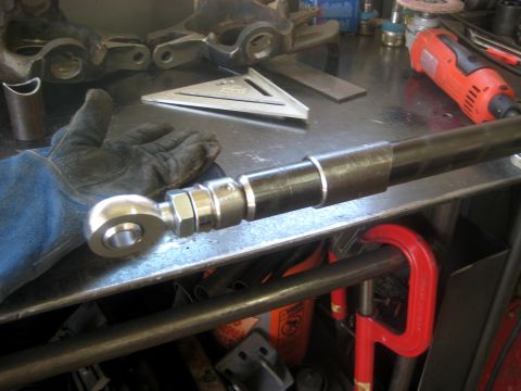 1996 Ford Bronco - Close-up of a tie rod end assembly on a workbench with tools.