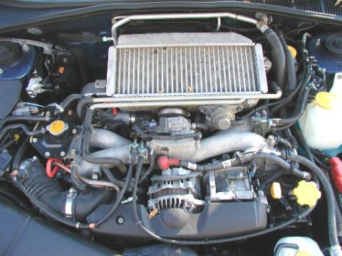 1990 Ford Bronco - The engine bay of a Subaru vehicle is shown, its intercooler and other engine components.