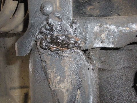 1988 Ford F-250 - This photo shows a heavily corroded and poorly repaired section of a vehicle's frame, likely requiring professional attention.