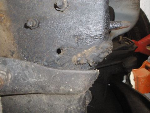 1988 Ford F-250 - Close-up view of a vehicle's frame, showing rust and bolted components.