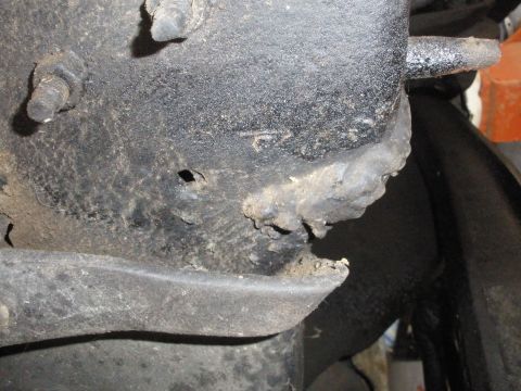 1988 Ford F-250 - This image shows a close-up of a corroded vehicle frame component, possibly indicating wear or damage.