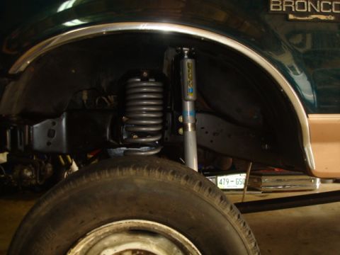 1995 Ford Bronco - The Bronco's suspension system, including a lifted coil spring and shock, is visible in this close-up shot.