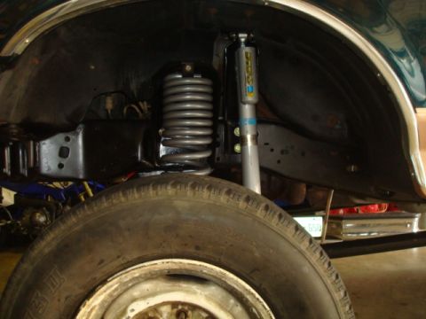 1995 Ford Bronco - Close-up view of the suspension system in a 1995 Ford Bronco, showing the coil spring and shock absorber.