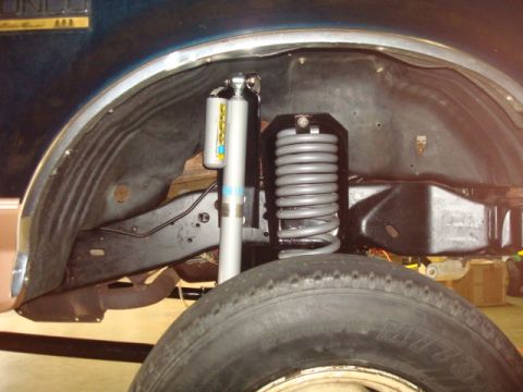 1995 Ford Bronco - Close-up of the rear suspension system on a 1995 Ford Bronco, highlighting the shocks and coil spring assembly.