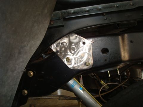 1995 Ford Bronco - Custom bracket installed on the vehicle's frame, near a Bilstein shock absorber.