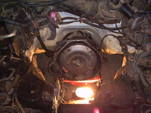 1991 Ford LTD Crown Victoria - Close-up view of a vehicle's transmission and engine bay, showing complex mechanical parts and wiring.