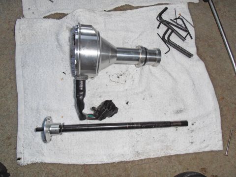 1990 Ford Bronco - Disassembled automotive distributor and shaft components laid out on a towel with tools.