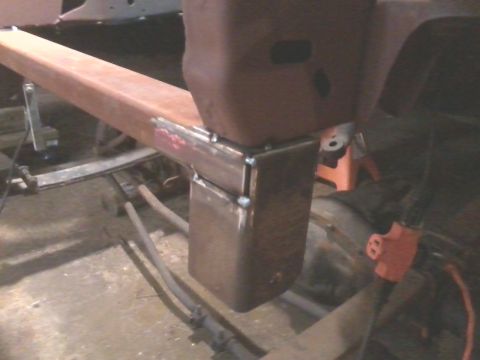 1985 Ford Bronco - Close-up of a custom-welded metal frame section, showing fabrication details and a red connector.