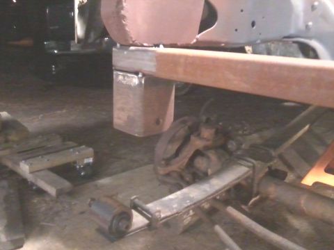 1985 Ford Bronco - Custom suspension work is underway on this vehicle's frame, showing modifications to the chassis and axle.