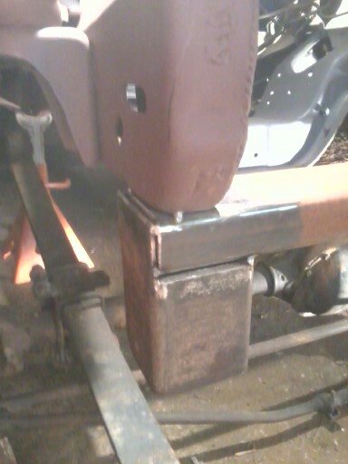 1985 Ford Bronco - Close-up of vehicle frame and suspension components, suggesting ongoing work or modification.