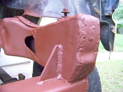 1985 Ford Bronco - Close-up of a heavily modified and welded vehicle frame section, likely for off-road use.