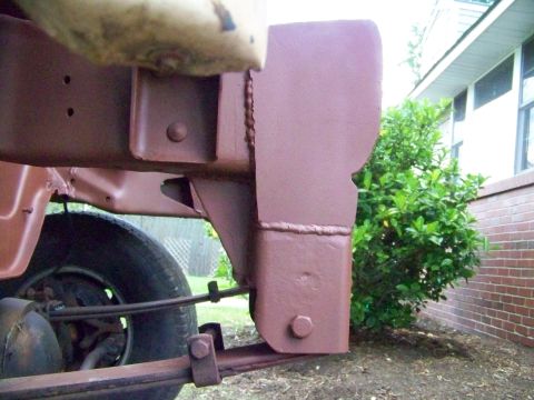 1985 Ford Bronco - Detail of vehicle frame and suspension components, painted brown.