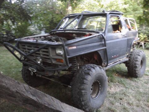 1986 Ford Bronco - This heavily modified SUV is equipped for off-road use with a prominent roll cage and oversized tires.