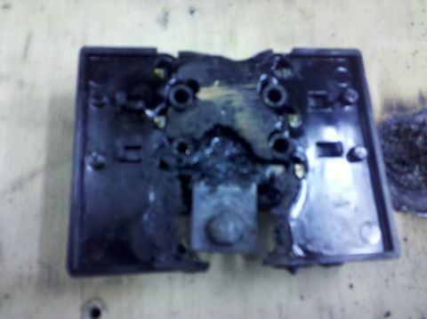 1995 Ford Bronco - This image shows a damaged black plastic automotive part with melted components and a Supermotors.net watermark.