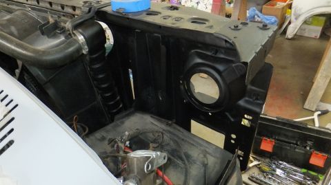 1983 Ford Bronco - Close-up view of a vehicle's engine bay, showing components like the radiator hose and headlight mounting area.