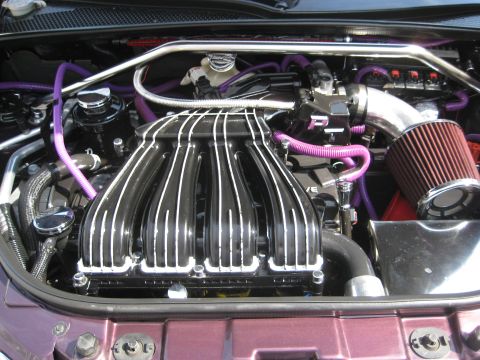 2005 Chrysler PT Cruiser - Engine bay modifications include purple hoses and a custom intake manifold with a red air filter.