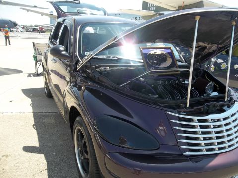 2005 Chrysler PT Cruiser - Customized 2005 Chrysler PT Cruiser on display with its hood open.