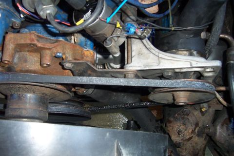 1980 Ford Bronco - Engine compartment detail showing the water pump, drive belts, and pulleys.