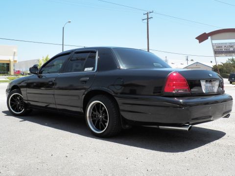 2003 Ford Crown Victoria - Rear-three-quarter of a lowered black Crown Victoria with dual exhaust and smoked lights.