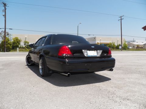 2003 Ford Crown Victoria - Lowered black Crown Victoria shot from behind showing taillights, Ford oval and twin exhaust tips.