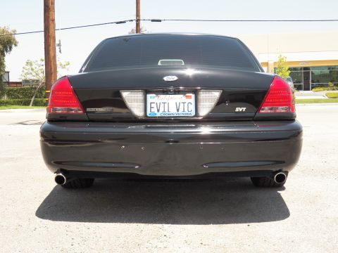 2003 Ford Crown Victoria - Tight rear shot of black Crown Victoria showing dual exhaust, California EVIL VIC plate and SVT lettering.