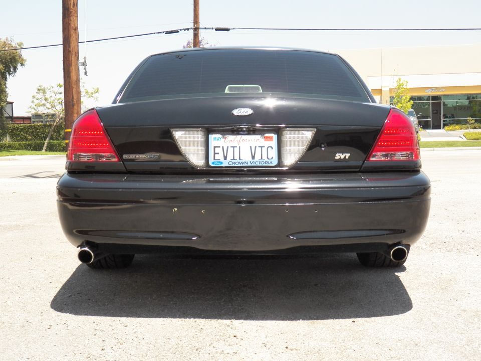 Black Ford Crown Victoria rear bumper close-up with EVIL VIC plate and SVT trunk badge