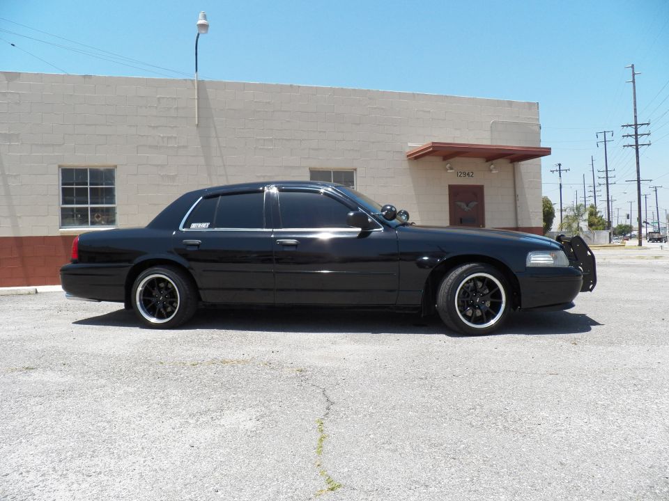 Black Ford Crown Victoria left-side profile with chrome trim and black wheels by building