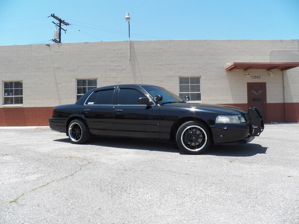 Black Ford Crown Victoria left front three-quarter with push bar and black wheels