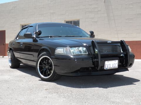 2003 Ford Crown Victoria - photograph of a black Crown Victoria, not a technical document.