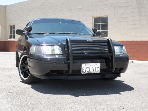 2003 Ford Crown Victoria - photograph of a black Crown Victoria, not a technical document.
