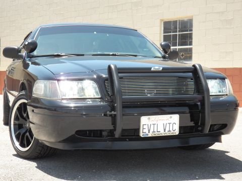2003 Ford Crown Victoria - photograph of a black Crown Victoria, not a technical document.