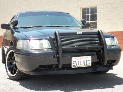2003 Ford Crown Victoria - Tight front view of a black Crown Victoria with brush guard, billet grille and EVIL VIC plate.