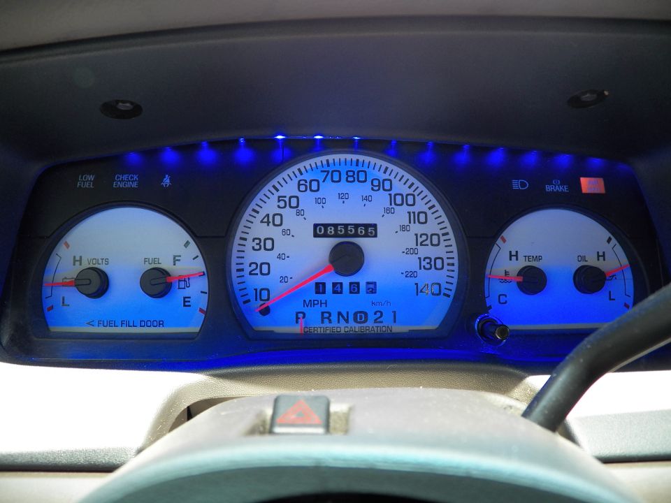 Crown Victoria instrument cluster lit blue, speedometer to 140 mph, odometer 085565