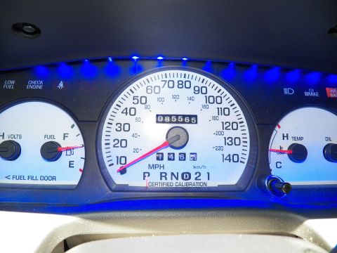 2003 Ford Crown Victoria - Tight view of a blue-lit speedometer reading at idle, 85,565 odometer and certified calibration text.