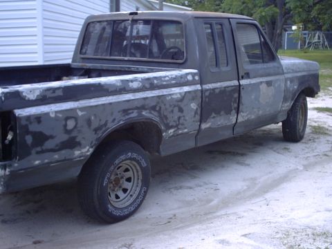 1989 Ford F-150 - This 1989 Ford F-150 pickup truck is shown in primer, indicating it is in the process of body work and paint.