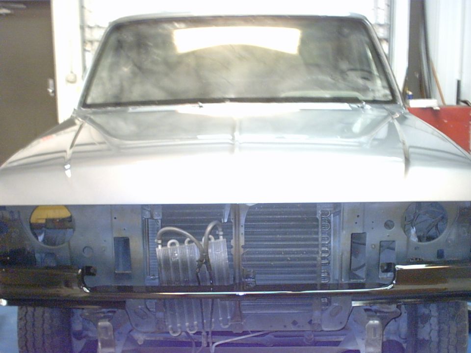 1987 Ford F-150 front end with grille removed, showing radiator and AC condenser