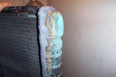 1980 Ford Bronco - This radiator has a JB Weld patch applied to its side tank, which shows signs of corrosion.