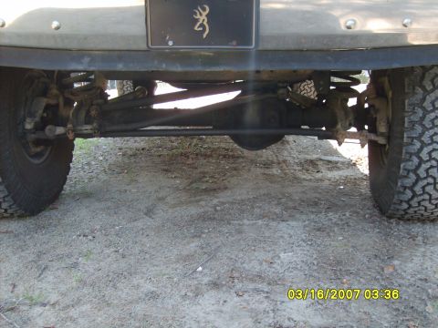 1989 Ford F-150 - The rear axle and suspension components of a truck are visible, along with a license plate frame a Browning logo.