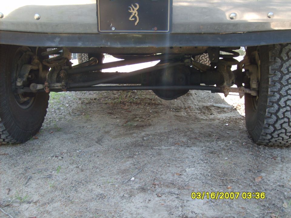 Truck rear axle and suspension with large tires and a Browning logo license plate frame