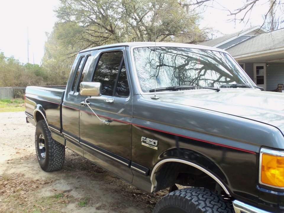 1989 Ford F-150 pickup truck, dark gray and black two-tone paint, side view