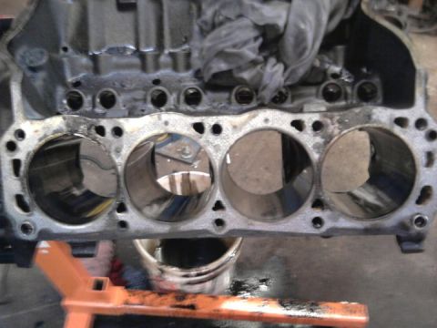 1989 Ford F-150 - Close-up of an engine block, showing cylinder bores and some internal components covered by cloth.