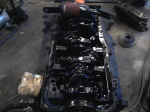 1989 Ford F-150 - The internal components of an engine block are visible, covered in oil.