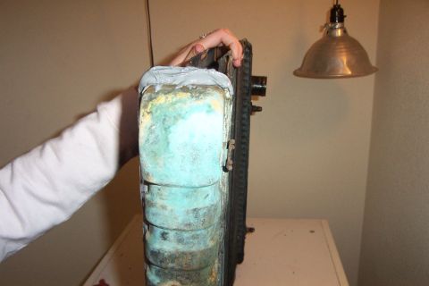 1980 Ford Bronco - A radiator shows a JB Weld repair on its side tank, indicating a patch job for a leak.