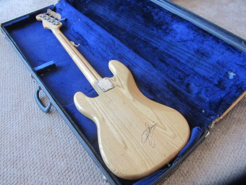 1968 Ford Mustang - A Fender Precision Bass guitar with a natural wood finish rests in its open blue velvet-lined case.