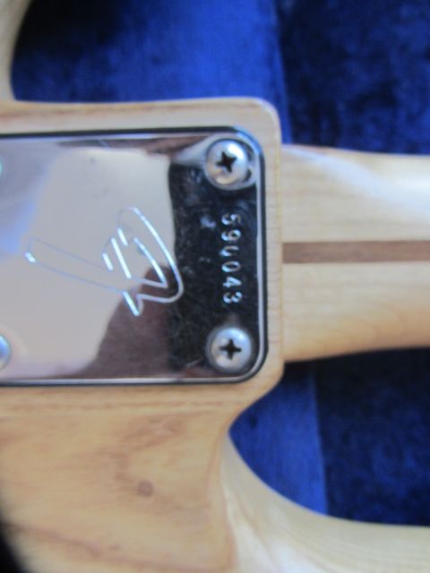 1968 Ford Mustang - The serial number 59043 is visible on the chrome neck plate of a Fender bass guitar.