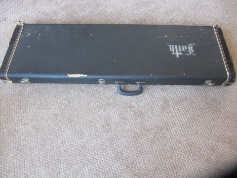 1968 Ford Mustang - A dark guitar case with the "Faith" logo is shown on a carpeted surface.
